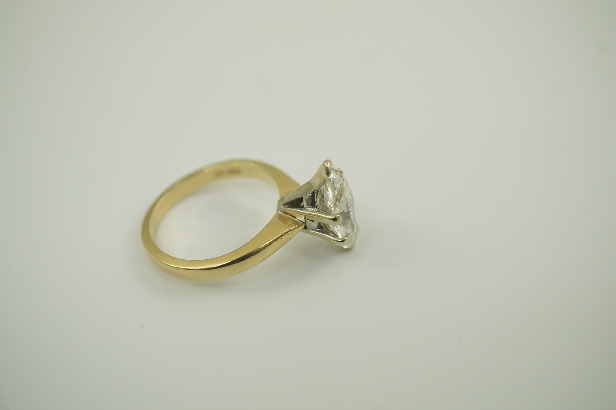 A modern 14k gold and solitaire marquise diamond set ring